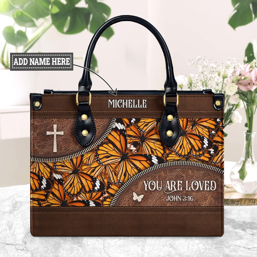 https://holisticbags.com/cdn/shop/products/You-Are-Loved-John-3-16-Butterfly-Pattern-DNRZ3101003A-Leather-Bag-newmk1_1024x1024.jpg?v=1699340023